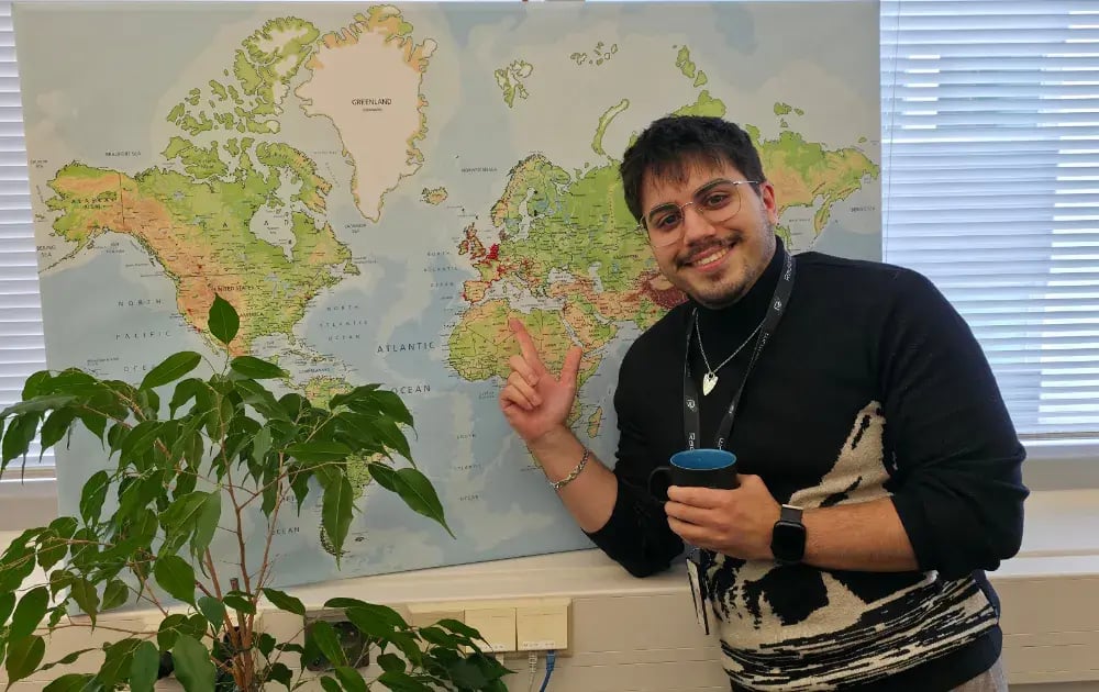 Tao Daniel pointing to a map with pins on customers